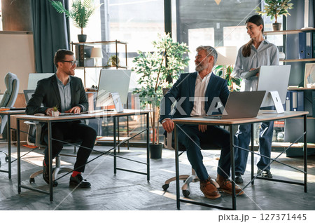 Using the pc's, sitting. Group of business people are working in the modern office 127371445