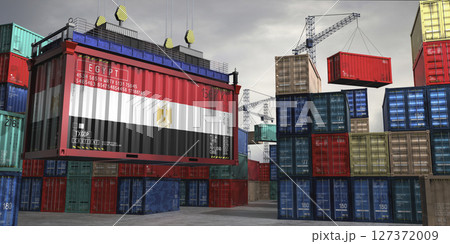 Cargo container with flag of Egypt lifted by crane at freight terminal - 3D illustration 127372009