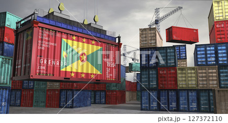 Cargo container with flag of Grenada lifted by crane at freight terminal - 3D illustration 127372110