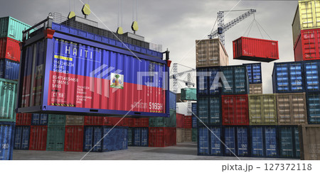 Cargo container with flag of Haiti lifted by crane at freight terminal - 3D illustration 127372118