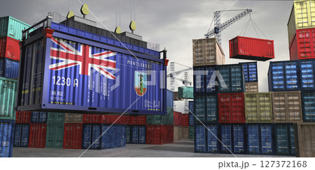 Cargo container with flag of Montserrat lifted by crane at freight terminal - 3D illustration 127372168