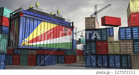 Cargo container with flag of Seychelles lifted by crane at freight terminal - 3D illustration Cargo container with flag of Seychelles lifted by crane at freight terminal - 3D illustration 127372211