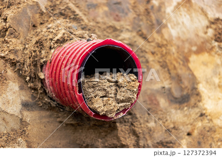 Water pipes for drinking water supply lie on the construction site. Preparation for earthworks for laying an underground pipeline. Modern water supply systems for a residential city. 127372394