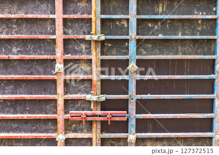 Reinforced concrete foundation of a modern monolithic residential building. Prepared formwork with reinforcing mesh for pouring concrete. Monolithic construction technologies. Reinforced concrete foundation of a modern monolithic residential building. Prepared formwork with reinforcing mesh for pouring concrete. Monolithic construction technologies. 127372515