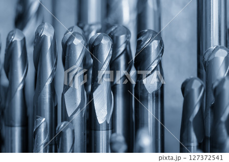 Close-up scene the group of used coating cutter ball nose end mill tools in the light blue scene. 127372541