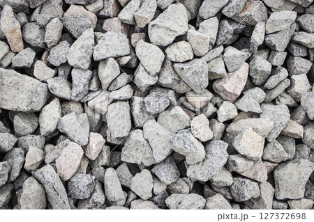 Aggregates of gravel piled in a construction site under bright daylight 127372698