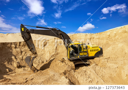 Yellow Excavator at Construction Site 127373643