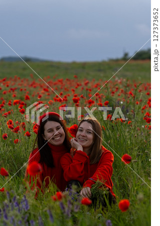 Women in Red in a Poppy Field Women in Red in a Poppy Field 127373652
