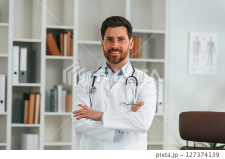 Standing in the office. Doctor in formal clothes is working in the cabinet 127374139