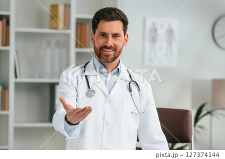 Standing in the office. Doctor in formal clothes is working in the cabinet 127374144