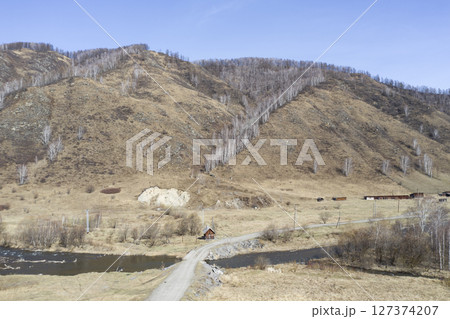 Aerial view of the village of Cherga at the mountains and the Sema River in the Altai Mountains Aerial view of the village of Cherga at the mountains and the Sema River in the Altai Mountains 127374207