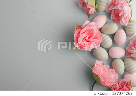 Easter eggs and spring flowers on pastel background. Top view Easter eggs and spring flowers on pastel background. Top view 127374268
