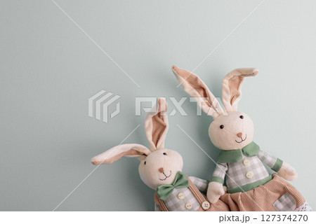 Family of Easter rabbits on pastel background. Top view Family of Easter rabbits on pastel background. Top view 127374270