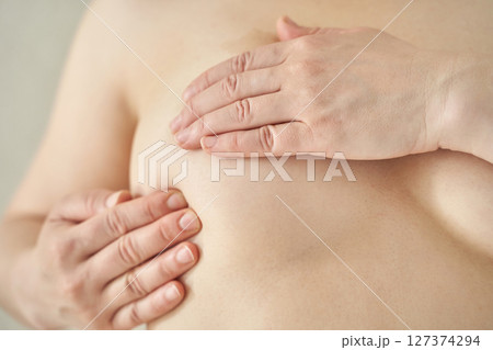 Asian female adult self-examining breast health awareness prevention care Asian female adult self-examining breast health awareness prevention care 127374294