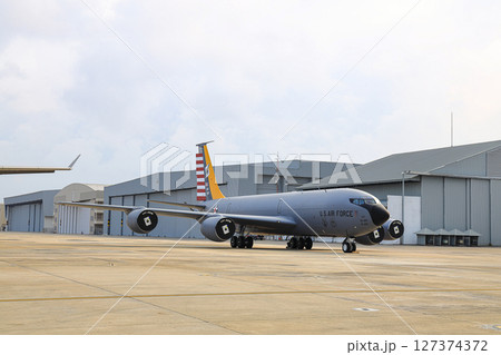 A United States Air Force military aerial refueling tanker Boing KC-130 Stratotanker at the airbase apron. 127374372