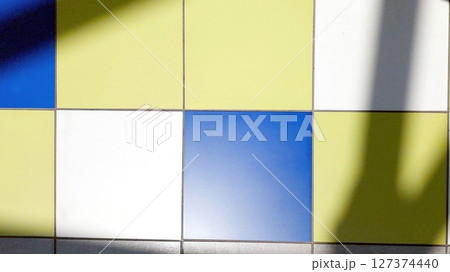 Colorful Tiled Floor With Shadows in a Brightly Lit Indoor Space During the Day Colorful Tiled Floor With Shadows in a Brightly Lit Indoor Space During the Day 127374440