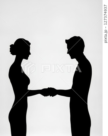 Silhouettes of man and woman shaking hands against a soft gradient background with copy space Silhouettes of man and woman shaking hands against a soft gradient background with copy space 127374937