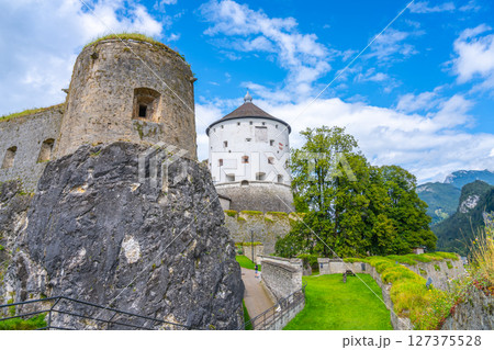 Visitors admire the historic Kufstein Fortress located in the scenic Tyrol region of Austria, surrounded by lush greenery and dramatic mountain views on a beautiful day. Visitors admire the historic Kufstein Fortress located in the scenic Tyrol region of Austria, surrounded by lush greenery and dramatic mountain views on a beautiful day. 127375528