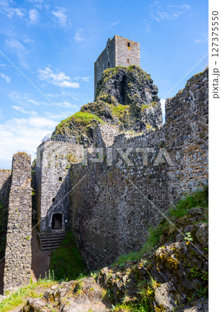 Panna Tower rises above the ancient ruins of Trosky Castle in Bohemian Paradise, Czechia. Visitors enjoy the scenic beauty and rich history of this captivating location on a clear day. Panna Tower rises above the ancient ruins of Trosky Castle in Bohemian Paradise, Czechia. Visitors enjoy the scenic beauty and rich history of this captivating location on a clear day. 127375550