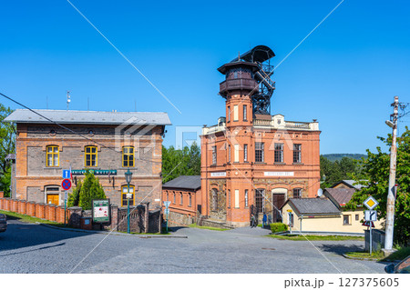 Historic structures of Sevcinsky mine in Brezove hory showcase Czechia's mining heritage. Bright sky illuminates the vibrant brickwork, with well-maintained landscaping enhancing the site. Historic structures of Sevcinsky mine in Brezove hory showcase Czechia's mining heritage. Bright sky illuminates the vibrant brickwork, with well-maintained landscaping enhancing the site. 127375605