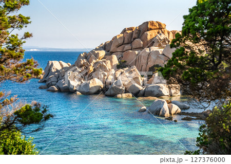 Granite boulders meet turquoise water in Sardinia, Italy, creating a scenic landscape Granite boulders meet turquoise water in Sardinia, Italy, creating a scenic landscape 127376000
