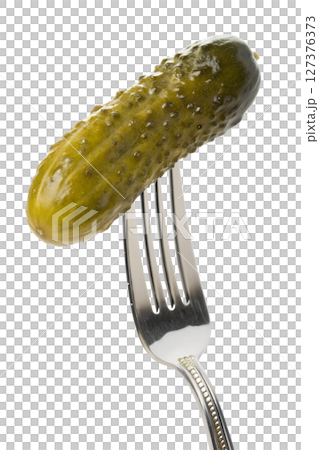 Pickle impaled on fork isolated, sour cucumber snack, close-up food shot, eating healthy concept 127376373