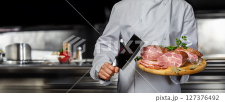Chef cooks gourmet meats in a pro kitchen. Chef cooks gourmet meats in a pro kitchen. 127376492