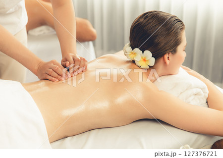 Caucasian couple customer enjoying relaxing anti-stress massage. Quiescent Caucasian couple customer enjoying relaxing anti-stress massage. Quiescent 127376721