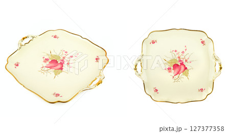 Set of Vintage plates of unusual shape with gold rim isolated on white background. Set of Vintage plates of unusual shape with gold rim isolated on white background. 127377358