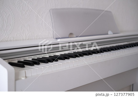 White piano stands in the hall White piano stands in the hall 127377905