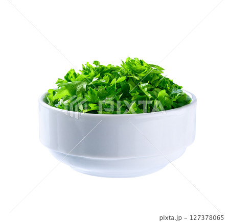 Chopped parsley in a ceramic bowl isolated on white background. Clipping path. Chopped parsley in a ceramic bowl isolated on white background. Clipping path. 127378065