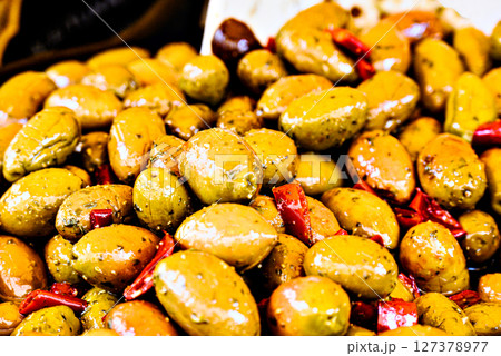 Container with fresh and delicious green olives Container with fresh and delicious green olives 127378977