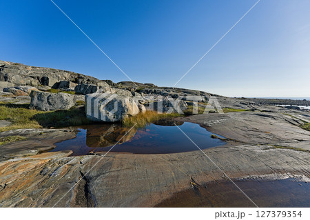Water puddle on the skerry island of Roeroe 127379354