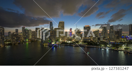 View from above of brightly illuminated high skyscraper buildings in downtown district of Miami Brickell in Florida, USA. American megapolis with business financial district at night 127381247