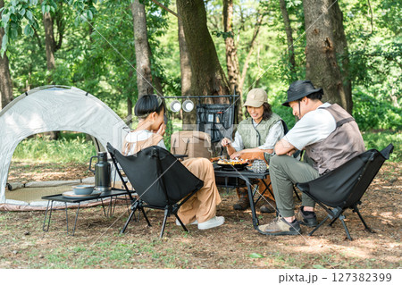 公園・キャンプ場でデイキャンプ・キャンプ・バーベキューを楽しむ仲良しのファミリー 公園・キャンプ場でデイキャンプ・キャンプ・バーベキューを楽しむ仲良しのファミリー 127382399
