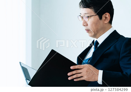 資料をチェックするビジネスマン 127384299