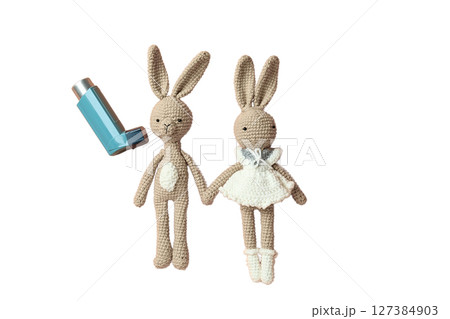 Health-themed crochet rabbits and inhalers, isolated on white Health-themed crochet rabbits and inhalers, isolated on white 127384903