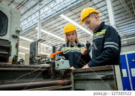 Workers inspecting machines in a paper mill. Large industry in paper production line. Workers inspecting machines in a paper mill. Large industry in paper production line. 127385522