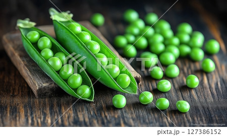 Fresh green peas in pods on a wooden surface with natural light 127386152