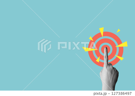 Human hand touching a dartboard on a colored background. Concept of taking action. Collage art Human hand touching a dartboard on a colored background. Concept of taking action. Collage art 127386497