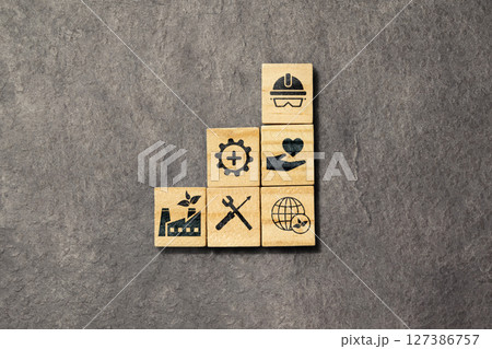 Wooden cubes with an HSE sign on a black background. Abbreviation of Health, Safety, and Environment. Industry standardization of a safe, healthy, and good environment 127386757
