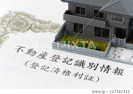 ミニチュアの一戸建て住宅と不動産登記識別情報(登記済権利証) ミニチュアの一戸建て住宅と不動産登記識別情報(登記済権利証) 127387332