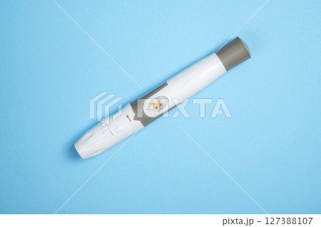 Lancet for checking blood sugar level. Concept of diabetes or a healthy lifestyle 127388107