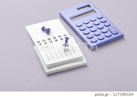 Calendar 2026 with pinned date and calculator on pastel purple background, business financial reminder, tax payment, budget planning 127390104