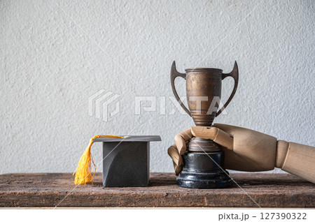 Graduating Student Achievement Trophy with Graduation Cap Display 127390322