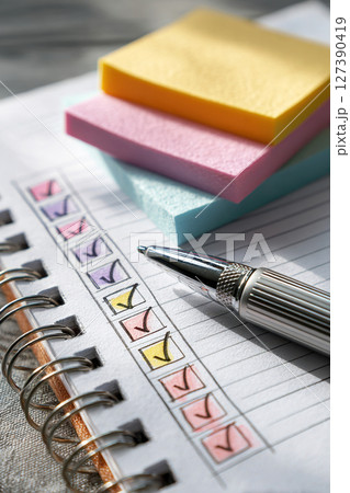 Checklist on notebook with pen and colorful sticky notes 127390419