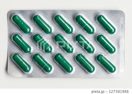 Blister pack containing green capsules commonly used for medications Blister pack containing green capsules commonly used for medications 127391988