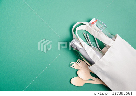 Eco friendly shopping bag with cutlery. Zero waste concept. Plastic free concept. Top view, flat lay, copy space. Eco friendly shopping bag with cutlery. Zero waste concept. Plastic free concept. Top view, flat lay, copy space. 127392561