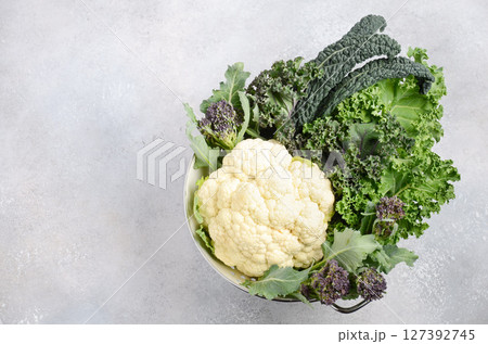 Different kinds of fresh organic cabbage on a gray concrete background. Green and Purple Kale, Broccoli, Savoy Cabbage, Cauliflower, Black Cabbage. Healthy diet food. 127392745