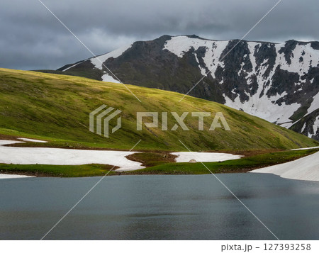 Alpine landscape with small white tent at very high altitude Alpine landscape with small white tent at very high altitude 127393258